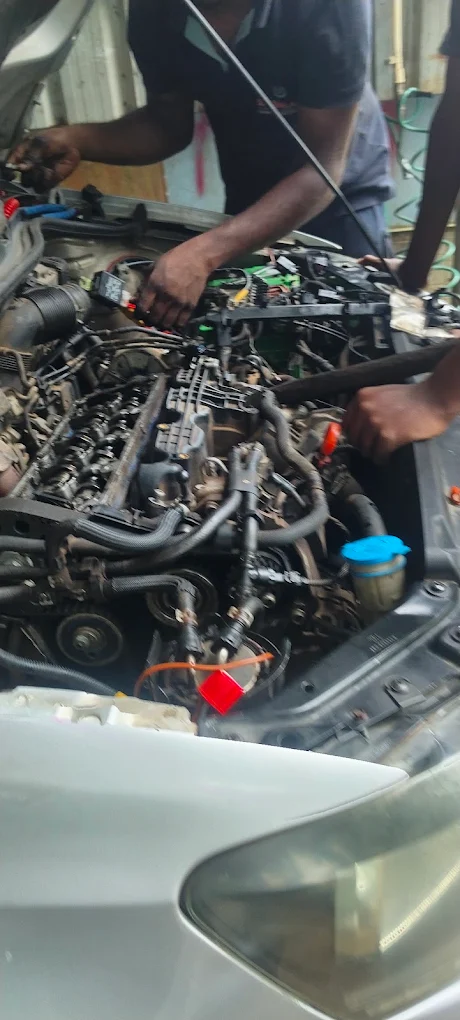 Technicians working on an engine bay